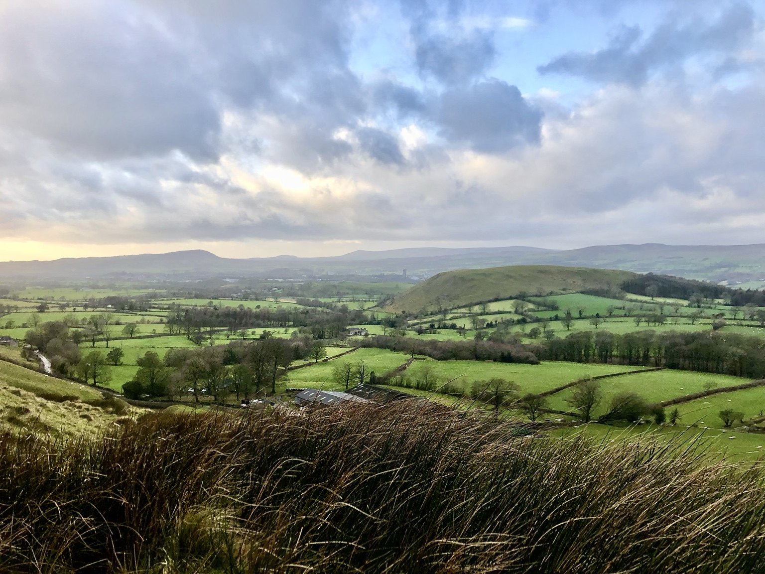 A rural Lancashire landscape near Lightbulb Law’s registered office, with fields, hedgerows and distant hills.